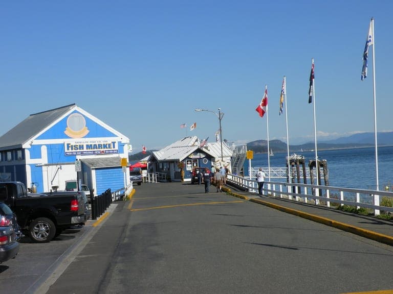 Sidney's waterfront pier with the fish market and flags, looking out over the water