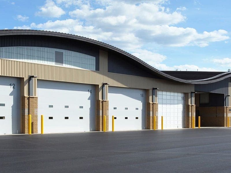 Insulated commercial sectional doors on a large industrial building