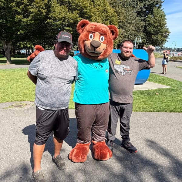 The Tedford bear mascot with two locals in a Nanaimo park